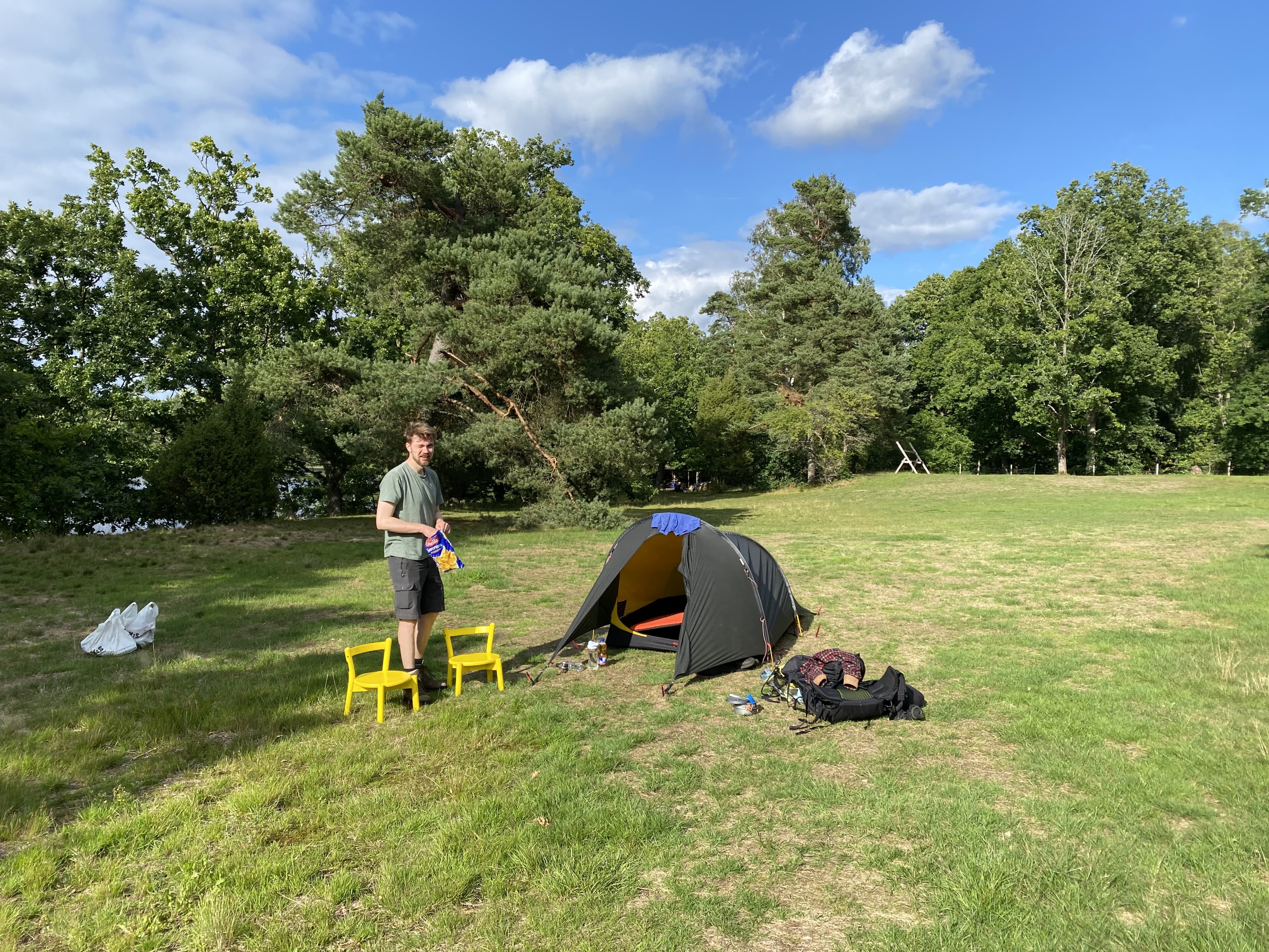 Our tent and gear at a peaceful campsite by the forest